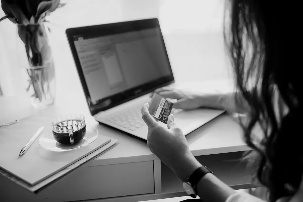 Online shopping on a laptop with a card