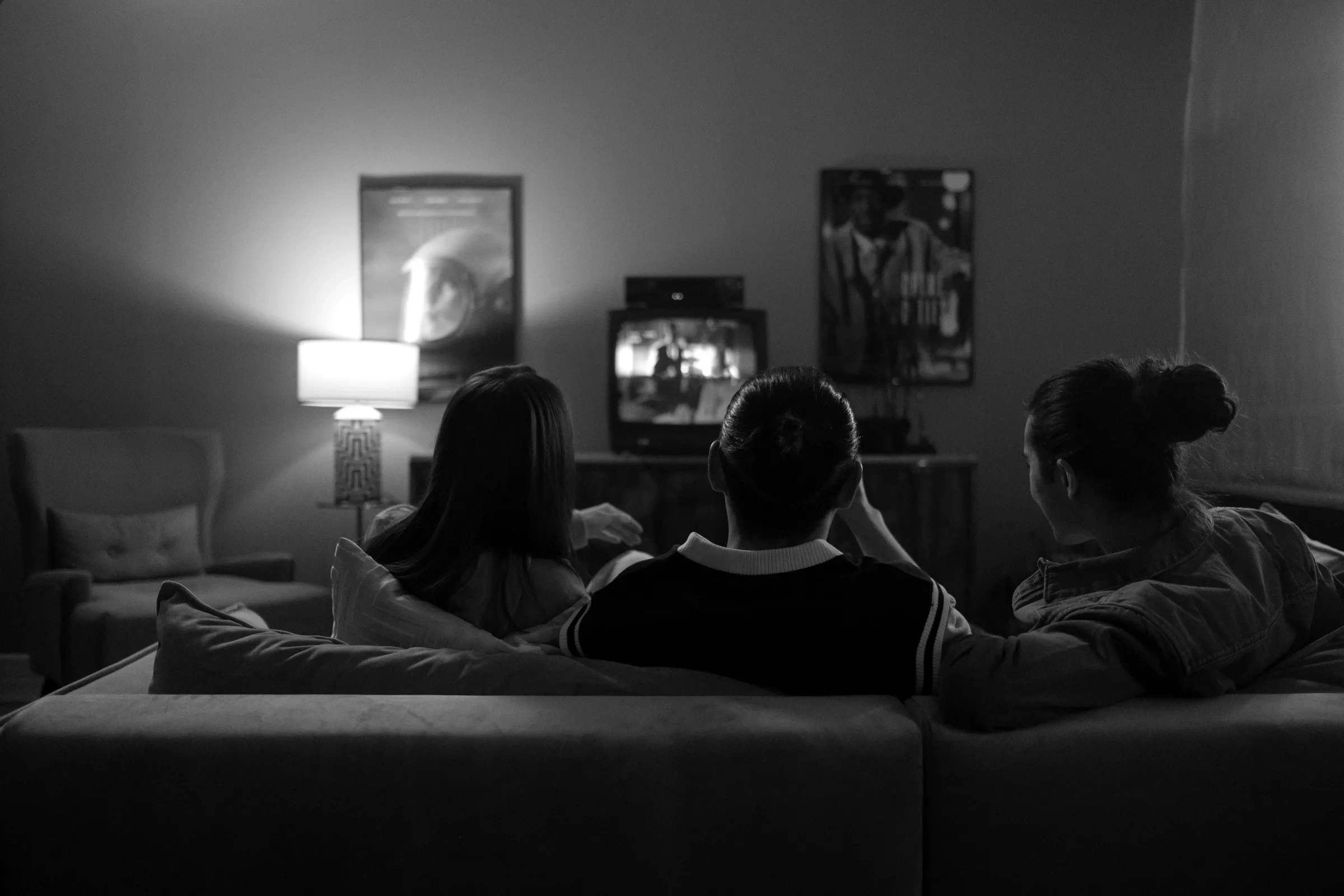 Friends watching television in a warm lounge room