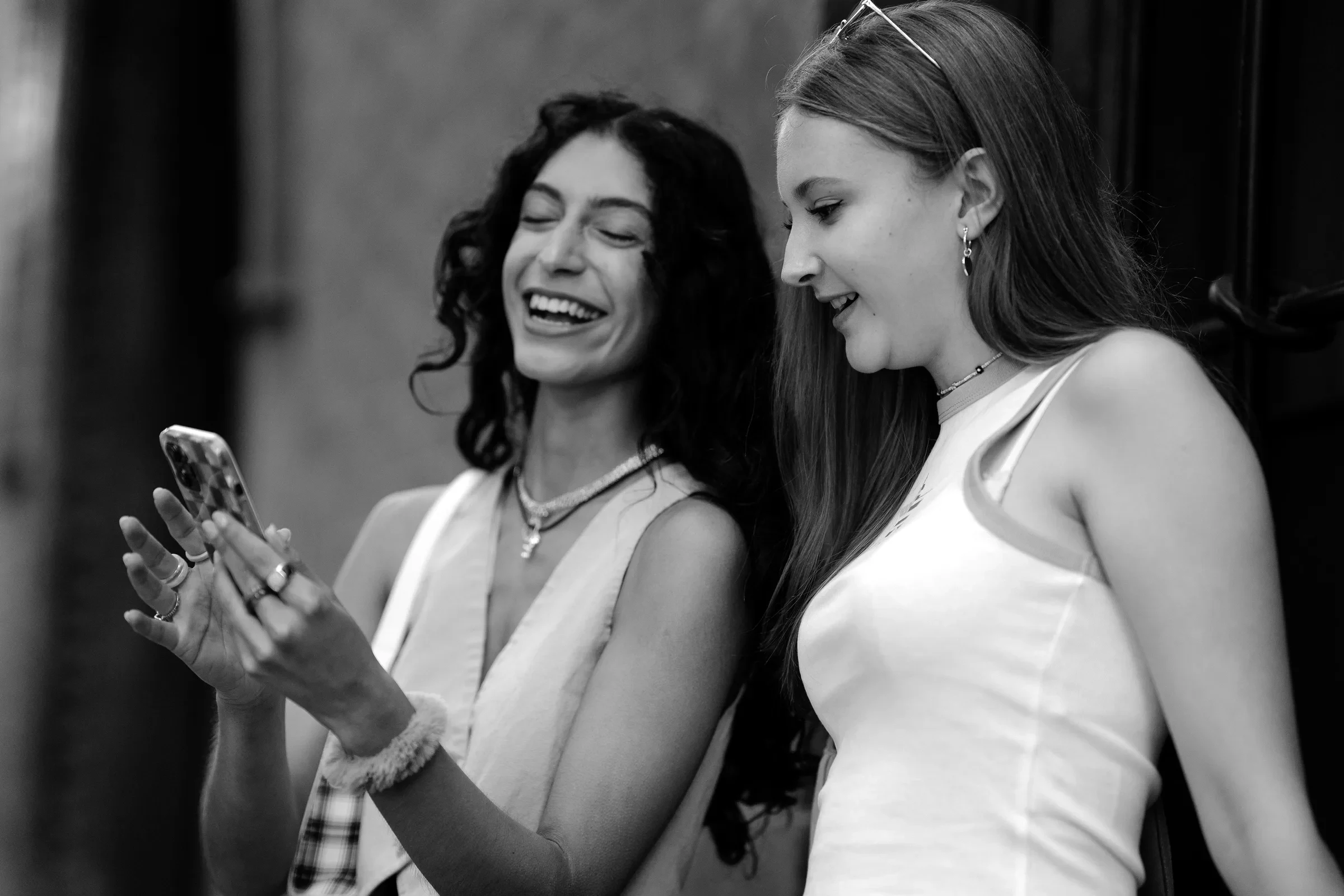 Two friends laughing at a post on a phone