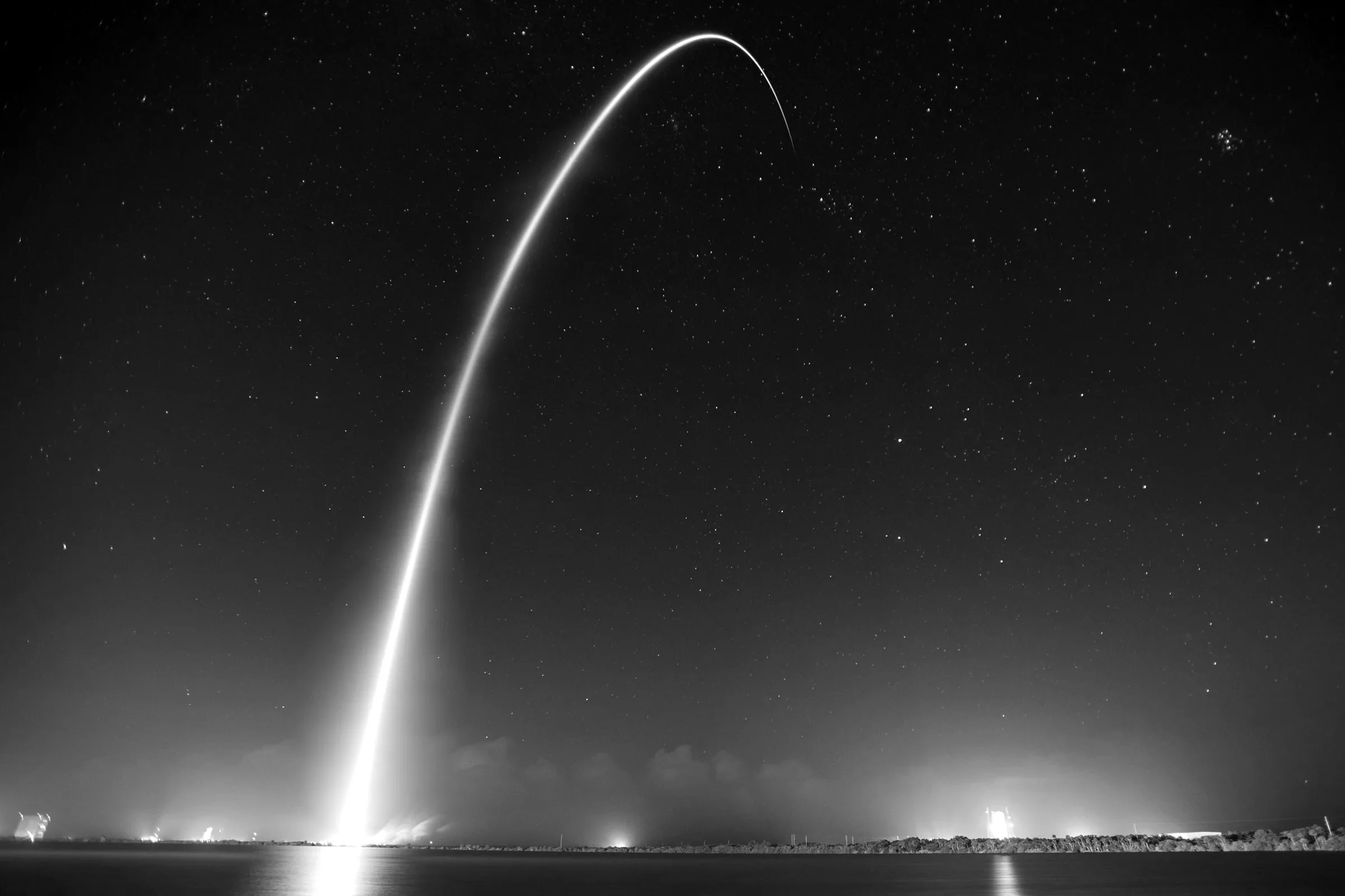 A rocket's launch arc across the night sky