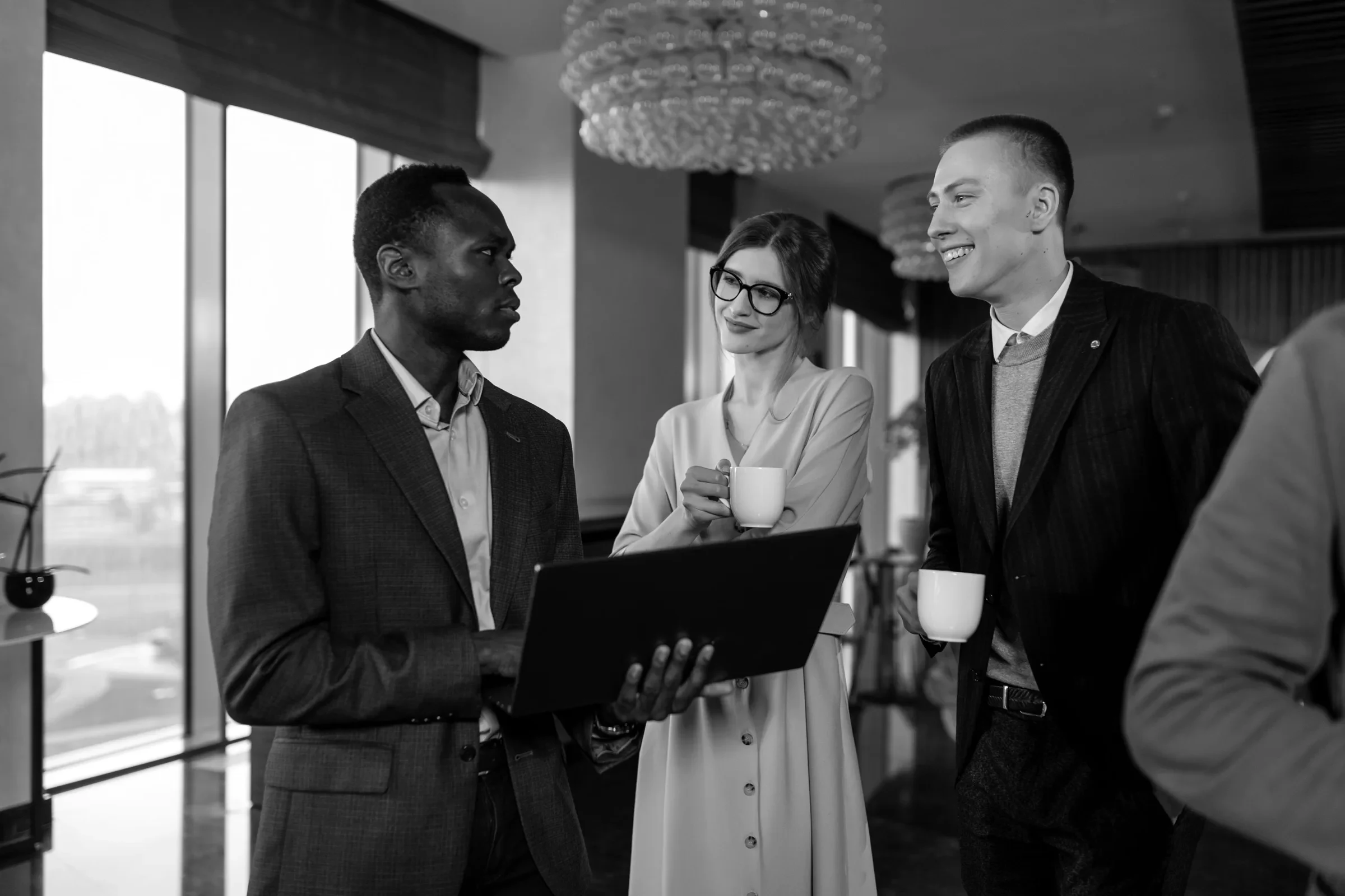 Professionals networking over a laptop at an event