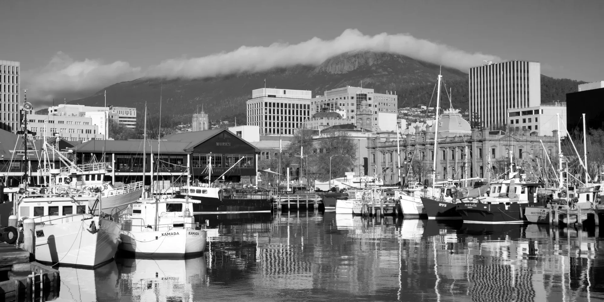 Fishing boats at Hobart's waterfront, with kunanyi / Mount Wellington behind